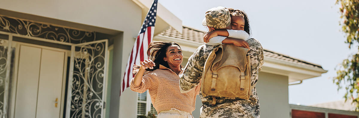 A veteran’s family welcoming him to their new home purchased with a VA mortgage loan.