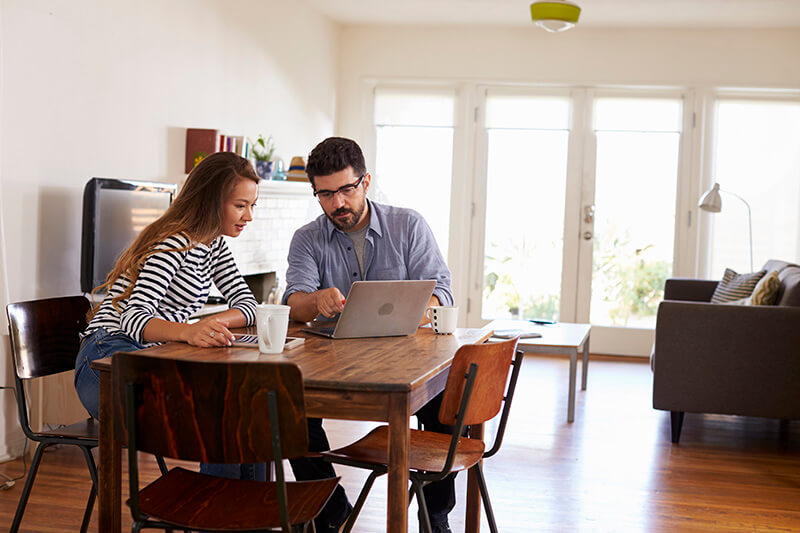 A married couple filling out a loan application with both of their information