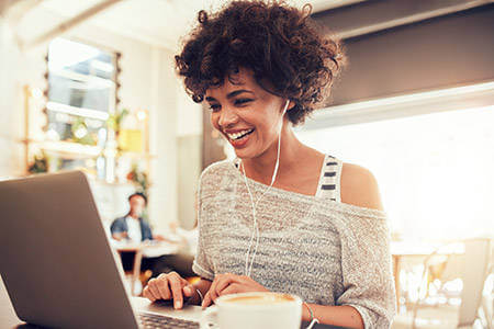 Woman researching mortgage refinance on her laptop.