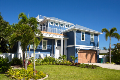 A blue house that was purchased out of state with out-of-state loan financing.