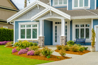 Front door of a blue home being sold.