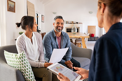 People discussing 15-year vs. 30-year fixed mortgage options with loan officer