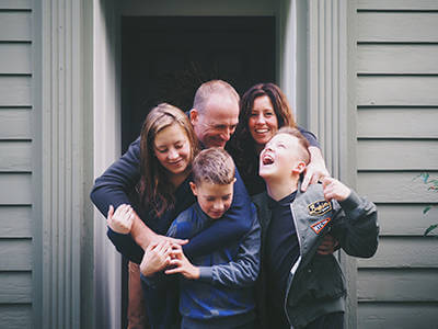 Family hugging and protecting their home