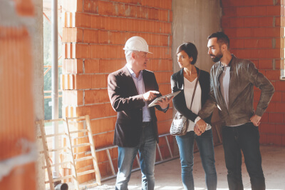 A couple speaking with their builder.