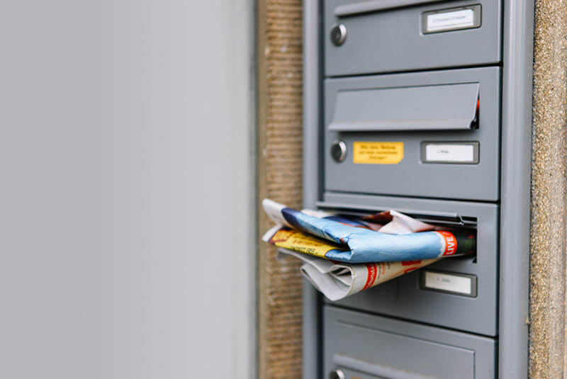 A mailbox filled with junk mail