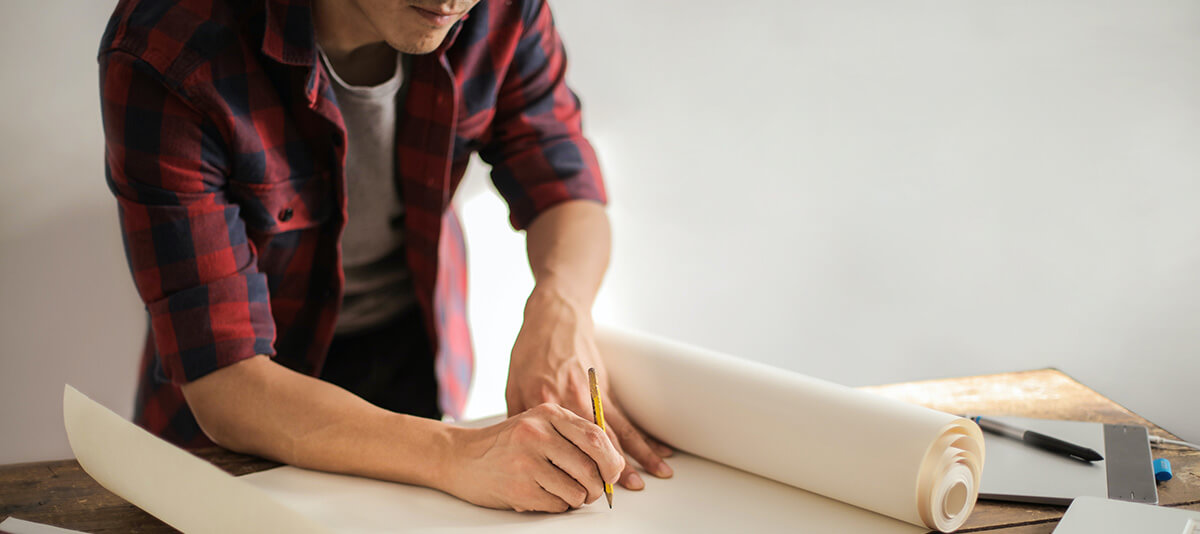 A renovation contractor drawing on the blueprints